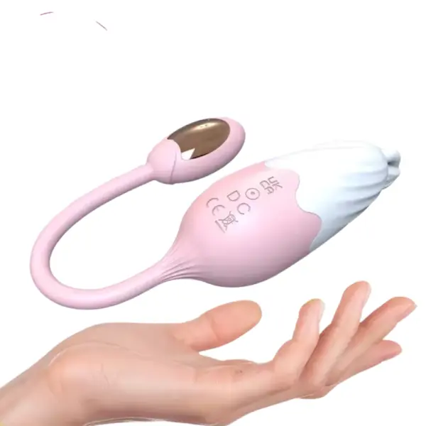 The Thermavie silicone heated love egg resting above an open hand, showing its compact size and flexible silicone tail.
