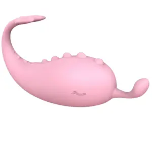 Side view of the Vibressa interactive egg in soft pink, shaped like a cute creature with a flexible tail and bumpy textured back, ending in a tongue-like stimulator.