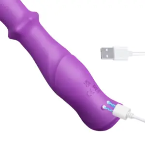 Close-up of the TriNova vibrator showing the magnetic USB charging port on its silicone surface, designed for convenience and waterproof sealing.