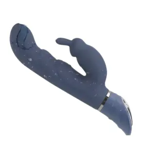 FlexNest rabbit vibrator covered in water droplets, highlighting its waterproof build and the ribbed texture of the shaft for added internal sensation.