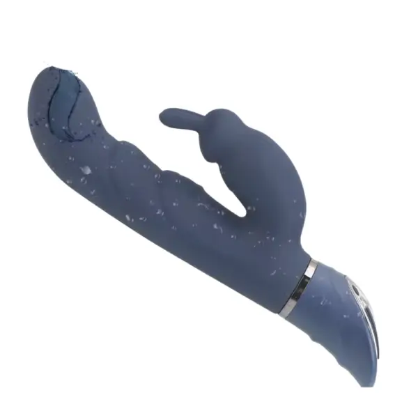 FlexNest rabbit vibrator covered in water droplets, highlighting its waterproof build and the ribbed texture of the shaft for added internal sensation.