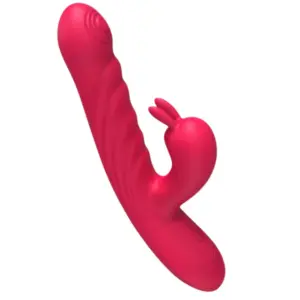 Close-up of the PlushPounce rabbit vibrator connected to a white USB charging cable, showing the power port and control buttons near the base.