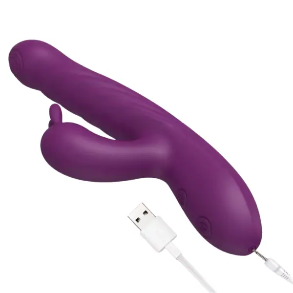 Close-up of the PlushPounce rabbit vibrator connected to a white USB charging cable, showing the power port and control buttons near the base.