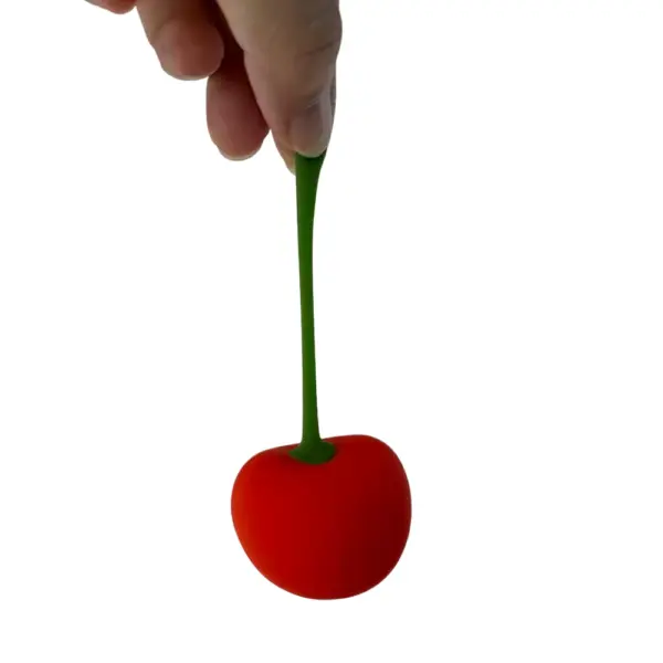 Cherry shaped bullet vibrator – CherryPop held by the green stem, highlighting its stretchable, flexible design and realistic fruit-inspired look.