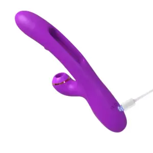 Flika vibrator charging through USB, with visible power port and the full-length curved shaft, showing its travel-friendly cordless design.