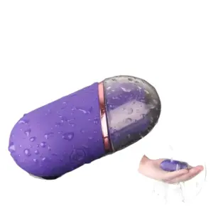 Mini clitoral suction stimulator – TinyTides shown covered in water droplets and being rinsed in a hand, demonstrating its waterproof design.
