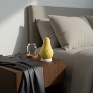 the pear vibrator resting on it's charging base on a night stand