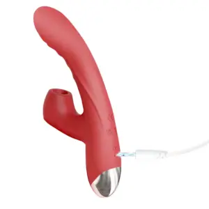 Clitoral Suction Rabbit Vibrator – BloomThrob pictured from the back with a charging cable plugged into the base, highlighting its USB rechargeable design.
