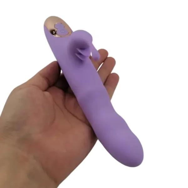 Lavender TapBun rabbit vibrator resting in hand, emphasizing compact size, tapping clitoral stimulator, and dual-button control at the base.