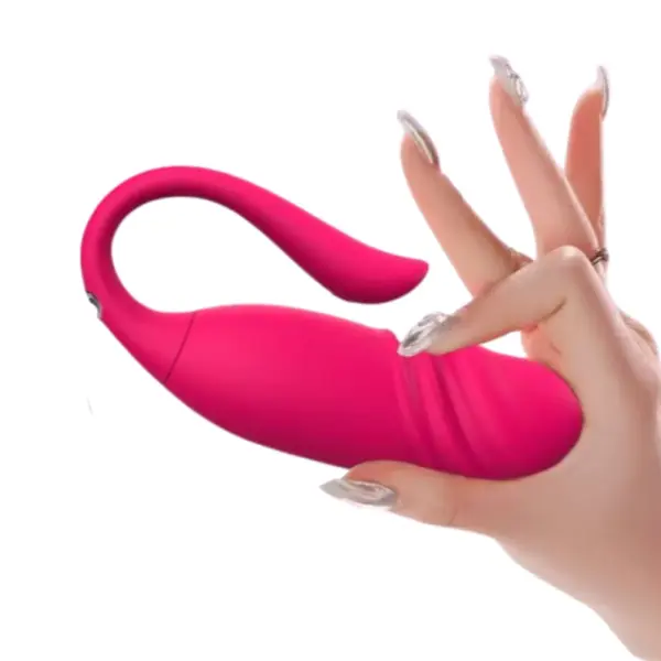 A hand holding the ViviTwist app controlled egg with thruster to show its compact size and soft silicone texture with a flexible tail design.