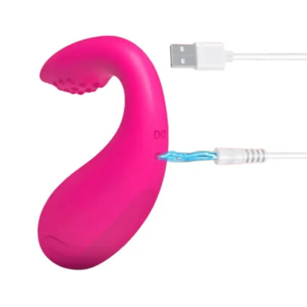 Close-up of TwinPulse stimulator showing the USB charging cable plugged into the base, highlighting its rechargeable and travel-friendly design.