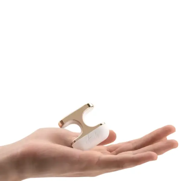 The Aurielle Luxury Finger Clip Vibrator resting in an open palm, highlighting its compact size and elegant curved shape.