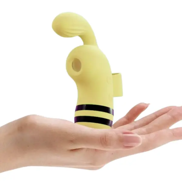 The Buzzora Bee Sucking Finger Vibrator resting in an open hand, highlighting its compact size, ergonomic shape, and bee-inspired design.