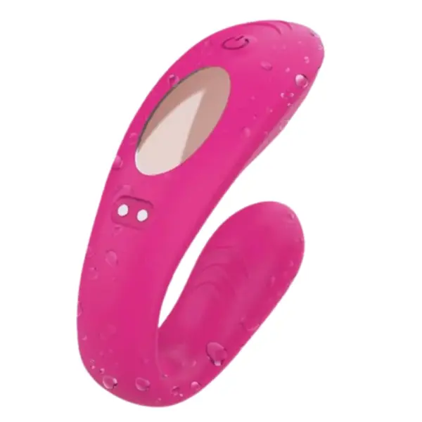 Close-up of the Luvoria Couples Vibrator with water droplets on its pink silicone body, highlighting the power button, remote sensor, and magnetic charging points.
