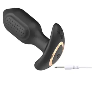 PulseDock textured anal vibrator with USB DC charging cable demonstrating the charging port and gold accent base.