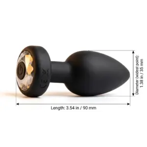 The Onyxra vibrating but plug laying on it's side with dimesnions for scale in milimeters and inches